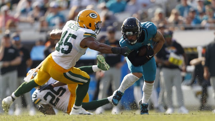 Oct 27, 2024; Jacksonville, Florida, USA; Green Bay Packers linebacker Eric Wilson (45) tackles Jacksonville Jaguars wide receiver Parker Washington (11) during the fourth quarter at EverBank Stadium. 