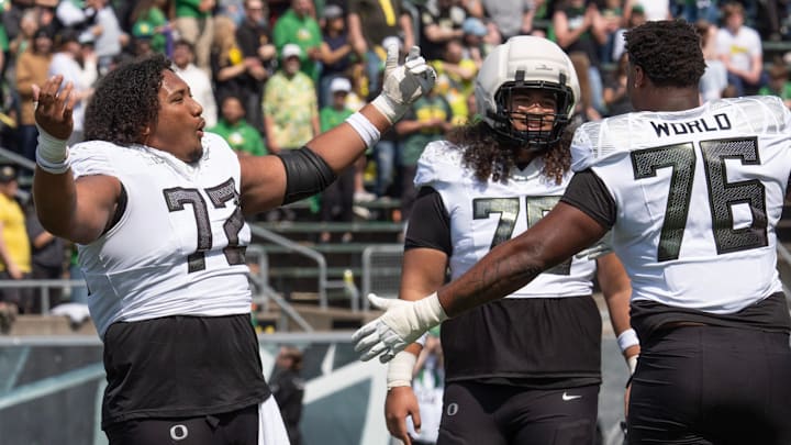 Oregon’s Iapani Laloulu, left, Lipe Moala and Isaiah World dance to the song “Shout” during the Oregon Spring Game at Autzen in Eugene April 26, 2025.