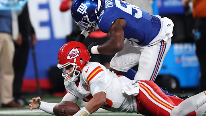 Sep 21, 2025; East Rutherford, New Jersey, USA; Kansas City Chiefs quarterback Patrick Mahomes (15) recovers a fumble against New York Giants inside linebacker Bobby Okereke (58) in the second quarter at MetLife Stadium. Mandatory Credit: Vincent Carchietta-Imagn Images