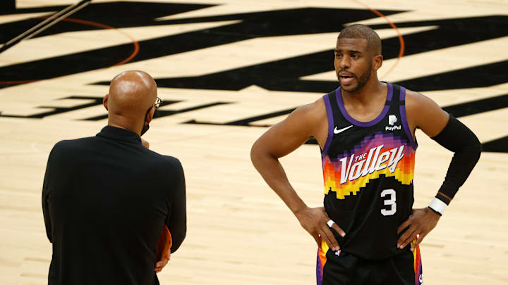 Former Phoenix Suns point guard Chris Paul speaks with head coach Monty Williams during Game 5 of the 2021 NBA Finals.