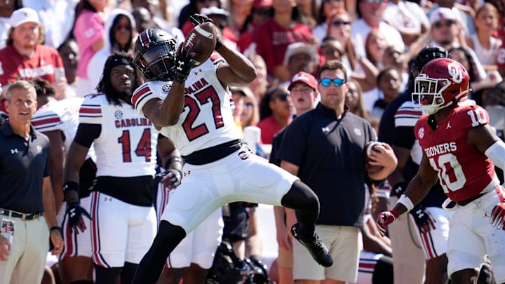 South Carolina Gamecocks running back Oscar Adaway III (27) catches a pass beside Oklahoma Sooners linebacker Kip Lewis (10) during a college football game between the University of Oklahoma Sooners (OU) and the South Carolina Gamecocks at Gaylord Family - Oklahoma Memorial Stadium in Norman, Okla., Saturday, Oct. 19, 2024. South Carolina Gamecocks running back Oscar Adaway III (27) catches a pass beside Oklahoma Sooners linebacker Kip Lewis (10) during a college football game between the University of Oklahoma Sooners (OU) and the South Carolina Gamecocks at Gaylord Family - Oklahoma Memorial Stadium in Norman, Okla., Saturday, Oct. 19, 2024.