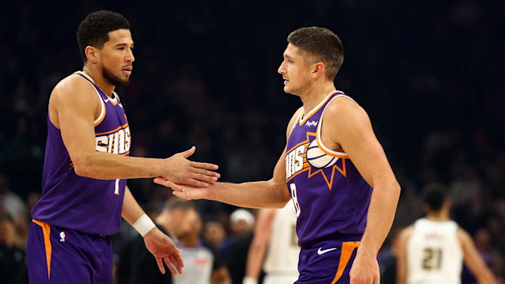 Nov 29, 2025; Phoenix, Arizona, USA; Phoenix Suns guard Devin Booker (left) with Grayson Allen against the Denver Nuggets in the first half at the Mortgage Matchup Center. Mandatory Credit: Mark J. Rebilas-Imagn Images