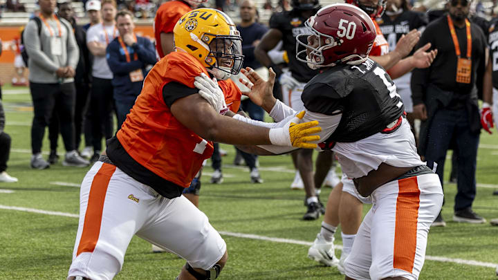Jan 28, 2025; Mobile, AL, USA; American team offensive lineman Miles Frazier of LSU (70) spars with American team linebacker Tim Smith of Alabama (5) during Senior Bowl practice for the American team at Hancock Whitney Stadium. Mandatory Credit: Vasha Hunt-Imagn Images