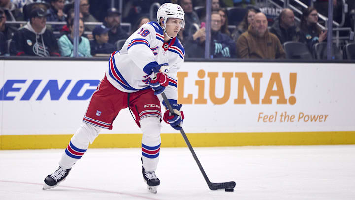 Nov 1, 2025; Seattle, Washington, USA; New York Rangers defenseman Urho Vaakanainen (18) passes the puck during the first period against the Seattle Kraken at Climate Pledge Arena. Mandatory Credit: Blake Dahlin-Imagn Images