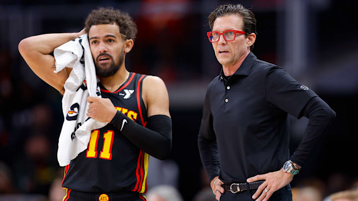 Trae Young #11 and Atlanta Hawks head coach Quin Snyder look on against the Denver Nuggets.