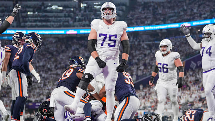 Dec 16, 2024; Minneapolis, Minnesota, USA; Minnesota Vikings offensive tackle Brian O'Neill (75) celebrates running back Cam Akers (27) touchdown against the Chicago Bears in the fourth quarter at U.S. Bank Stadium.