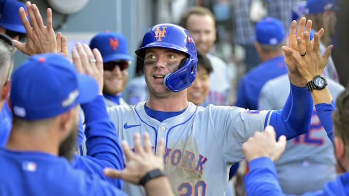 Oct 14, 2024; Los Angeles, California, USA; New York Mets first baseman Pete Alonso (20) celebrates in the dugout after scoring in the ninth inning against the Los Angeles Dodgers during game two of the NLCS for the 2024 MLB Playoffs at Dodger Stadium. Mandatory Credit: Jayne Kamin-Oncea-Imagn Images