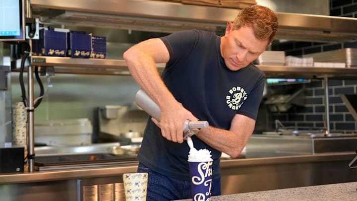 CHARLOTTE, NORTH CAROLINA - JULY 17: Chef Bobby Flay Celebrates Bobby's Burgers By Bobby Flay's Grand Opening Event In Charlotte, NC, The First Neighborhood on July 17, 2024 in Charlotte, North Carolina. (Photo by Grant Halverson/Getty Images for Bobby's Burgers by Bobby Flay)