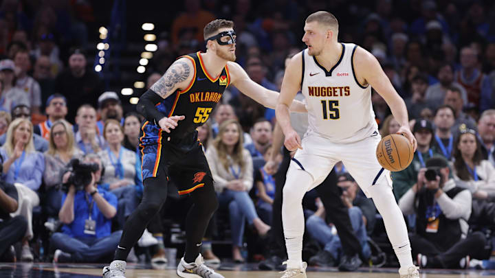 Mar 9, 2025; Oklahoma City, Oklahoma, USA; Oklahoma City Thunder center Isaiah Hartenstein (55) defends a drive by Denver Nuggets center Nikola Jokic (15) during the second half at Paycom Center. Mandatory Credit: Alonzo Adams-Imagn Images