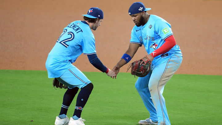 Oct 29, 2025; Los Angeles, California, USA; Toronto Blue Jays first baseman Vladimir Guerrero Jr. (27) celebrates with third baseman Ernie Clement (22) after defeating the Los Angeles Dodgers in game five of the 2025 MLB World Series at Dodger Stadium. 