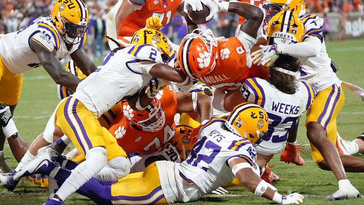 Aug 30, 2025; Clemson, South Carolina, USA; Clemson Tigers running back Adam Randall (8) rushes for a touchdown as LSU Tigers linebacker West Weeks (33) loses his helmet during the second quarter at Memorial Stadium. Mandatory Credit: Ken Ruinard-USA TODAY Network via Imagn Images