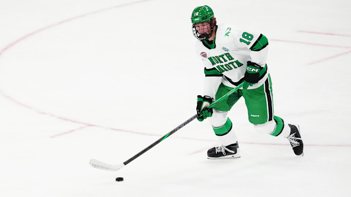 Apr 9, 2026; Las Vegas, Nevada, UNITED STATES;  North Dakota Fighting Hawks defenseman Keaton Verhoeff (18) moves the puck in the first period against the Wisconsin Badgers  in the semifinals of the NCAA men's ice hockey Frozen Four at T-Mobile Arena. Mandatory Credit: Stephen R. Sylvanie-Imagn Images
