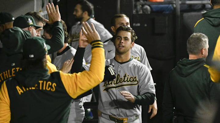 Apr 15, 2025; Chicago, Illinois, USA;   Athletics second baseman Max Muncy (10) celebrates in the dugout after he scores against the Chicago White Sox  during the sixth inning at Rate Field.  “All players wore #42 for Jackie Robinson Day” Mandatory Credit: Matt Marton-Imagn Images. 