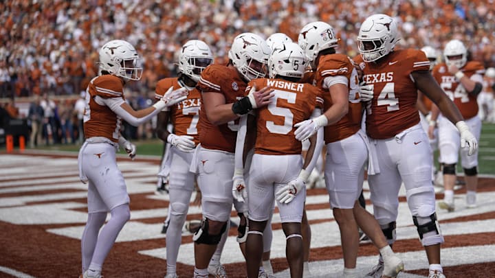 Texas Longhorns celebrate after running back Quintrevion Wisner (5) runs for a touchdown in the first half against the Vanderbilt Commodores at Darrell K Royal-Texas Memorial Stadium.
