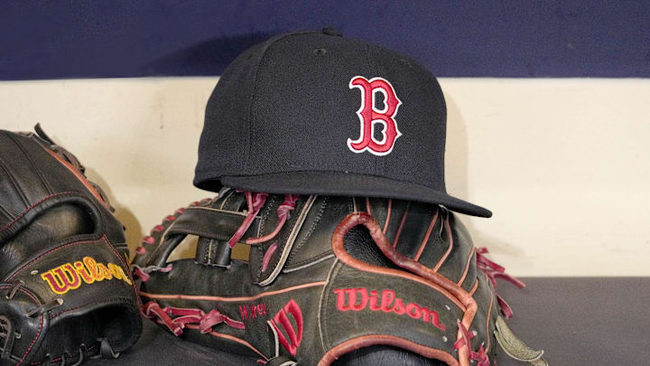 May 27, 2025; Milwaukee, Wisconsin, USA; A Boston Red Sox hat and glove sit in the dug out before a game against the Milwaukee Brewers at American Family Field. Mandatory Credit: Michael McLoone-Imagn Images