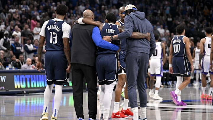 Dallas Mavericks guard Irving (is helped off the court by forward Marshall and forward Davis during the second quarter against the Sacramento Kings at the American Airlines Center. 