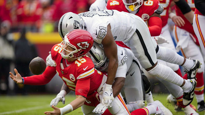 Chiefs quarterback Patrick Mahomes (15) recovers his fumble as he is hit by Raiders defensive end Malcolm Koonce (51)