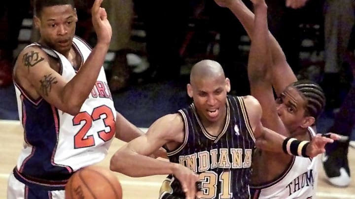 Indiana Pacers' forward Reggis Miller (C) loses th