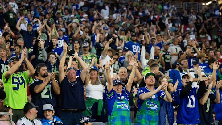 Dec 8, 2024; Glendale, Arizona, USA; Seattle Seahawks fans in the crowd cheer against the Arizona Cardinals at State Farm Stadium.