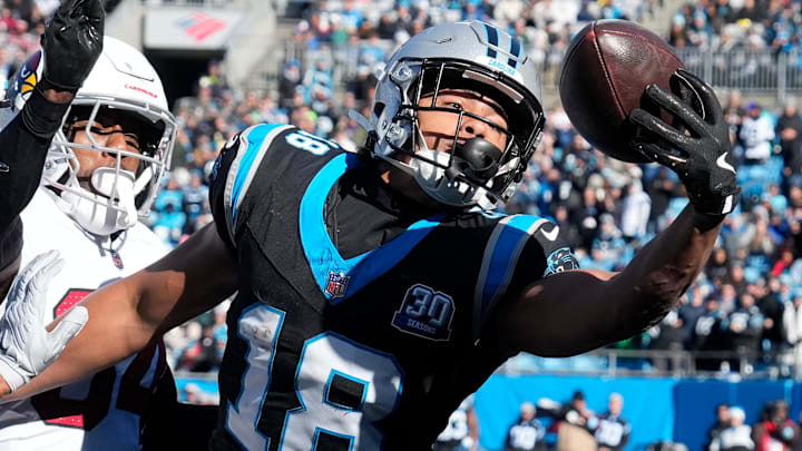 Dec 22, 2024; Charlotte, North Carolina, USA; Carolina Panthers wide receiver Jalen Coker (18) attempts to catch the ball in the end zone as Arizona Cardinals safety Jalen Thompson (34) defends in the first quarter at Bank of America Stadium. Mandatory Credit: Bob Donnan-Imagn Images
