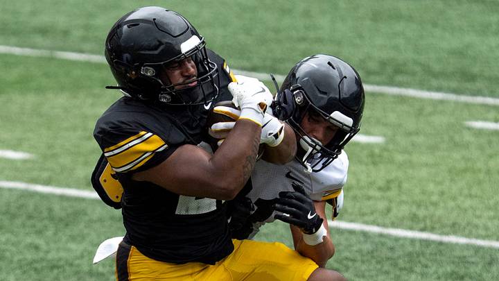 Iowa running back L.J. Phillips Jr. (21) is tackled by Iowa defensive back Marcello Vitti (21) while carrying the ball Aug. 15, 2026 during the Kids Day at Kinnick open practice at Kinnick Stadium in Iowa City, Iowa. Iowa running back L.J. Phillips Jr. (21) is tackled by Iowa defensive back Marcello Vitti (21) while carrying the ball Aug. 15, 2026 during the Kids Day at Kinnick open practice at Kinnick Stadium in Iowa City, Iowa.