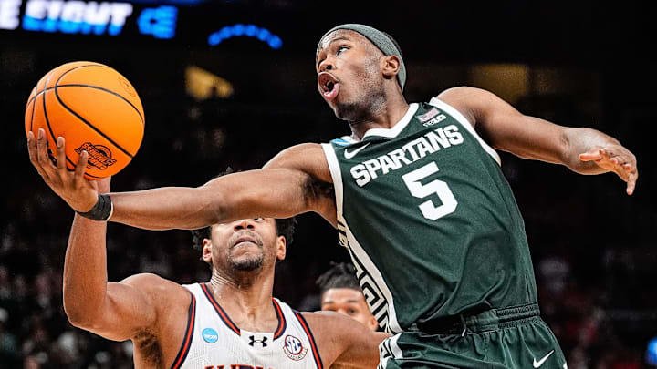 Michigan State guard Tre Holloman misses a layup against Auburn center Dylan Cardwell during the first half of the Elite Eight round of the NCAA tournament at State Farm Arena in Atlanta, Ga. on Sunday, March 30, 2025. Michigan State guard Tre Holloman misses a layup against Auburn center Dylan Cardwell during the first half of the Elite Eight round of the NCAA tournament at State Farm Arena in Atlanta, Ga. on Sunday, March 30, 2025.