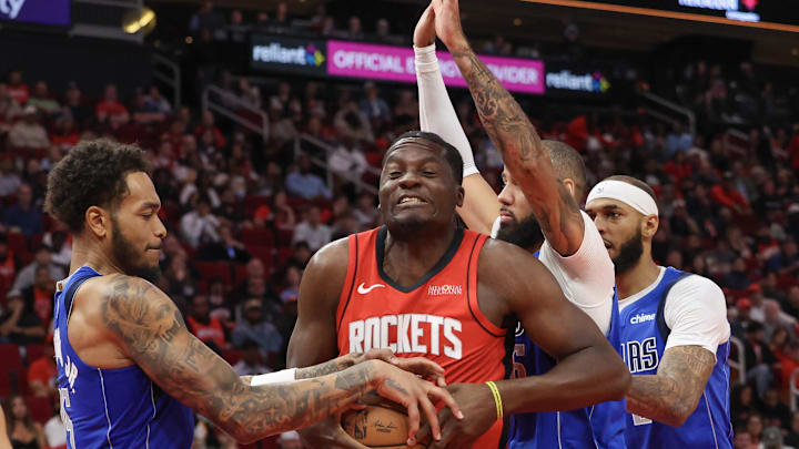 Clint Capela of the Rockets securing the basketball from the Mavericks
