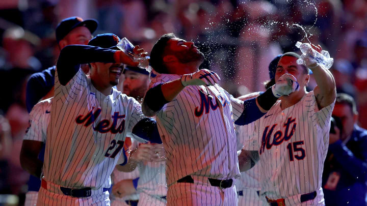 Jun 13, 2024; New York City, New York, USA; New York Mets third baseman Mark Vientos (27) and right fielder Tyrone Taylor (15) pour water on designated hitter J.D. Martinez (28) after his ninth inning walkoff two run home run against the Miami Marlins at Citi Field. Mandatory Credit: Brad Penner-USA TODAY Sports