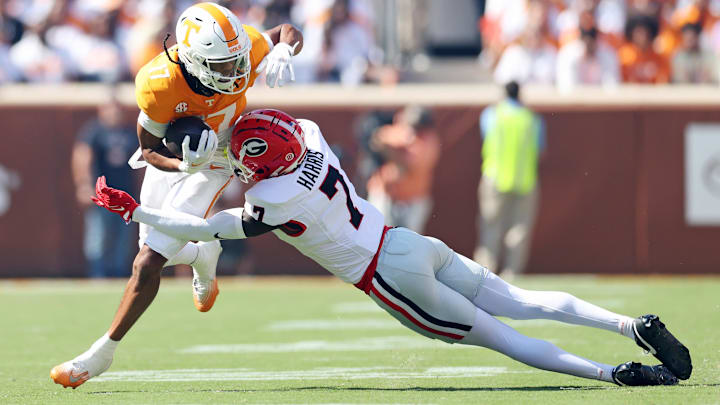 Sep 13, 2025; Knoxville, Tennessee, USA; Tennessee Volunteers wide receiver Chris Brazzell II (17) runs the ball as Georgia Bulldogs defensive back Daniel Harris (7) defends during the first half at Neyland Stadium. Mandatory Credit: Alan Poizner-Imagn Images
