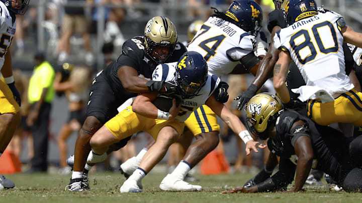Oct 18, 2025; Orlando, Florida, USA; Central Florida Knights defensive tackle Derrick LeBlanc (88) sacks West Virginia Mountaineers quarterback Scotty Fox Jr. (15) in the first half at Acrisure Bounce House. Oct 18, 2025; Orlando, Florida, USA; Central Florida Knights defensive tackle Derrick LeBlanc (88) sacks West Virginia Mountaineers quarterback Scotty Fox Jr. (15) in the first half at Acrisure Bounce House.