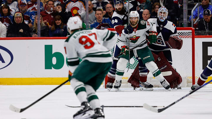 Mar 8, 2026; Denver, Colorado, USA; Colorado Avalanche defenseman Brent Burns (84) and Minnesota Wild right wing Ryan Hartman (38) battle for position in front of goaltender Scott Wedgewood (41) as left wing Kirill Kaprizov (97) controls the puck in the second period at Ball Arena. Mandatory Credit: Isaiah J. Downing-Imagn Images