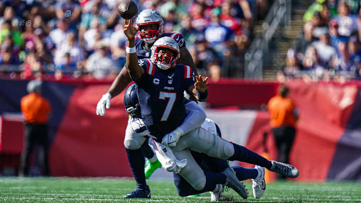 Sep 15, 2024; Foxborough, Massachusetts, USA; New England Patriots quarterback Jacoby Brissett (7) tries to pass the ball under pressure from the Seattle Seahawks in the second half at Gillette Stadium. Mandatory Credit: David Butler II-Imagn Images