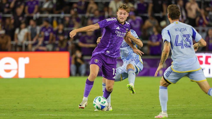 Apr 26, 2025; Orlando, Florida, USA; Orlando City forward Duncan McGuire (13) battles for the ball against Atlanta United defender Noah Cobb (24) during the second half at Inter&Co Stadium. Mandatory Credit: Mike Watters-Imagn Images
