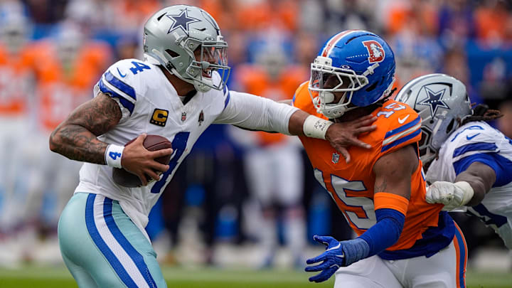 October 26, 2025: Dallas Cowboys quarterback Dak Prescott (4) fends off Denver Broncos linebacker Nik Bonitto (15) before being sacked in the first half of the football game between the Denver Broncos and Dallas Cowboys. 