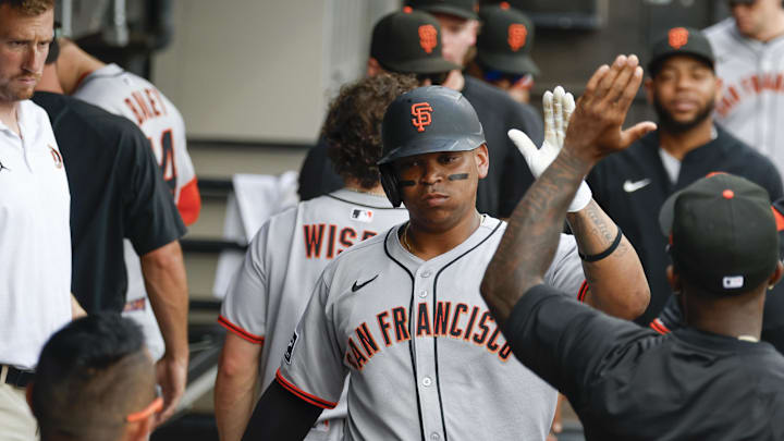 Chicago, Illinois, USA; San Francisco Giants designated hitter Rafael Devers (16) celebrates in the dugout after scoring against the Chicago White Sox during the fifth inning at Rate Field.