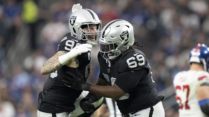 November 5, 2023; Paradise, Nevada, USA; Las Vegas Raiders defensive end Maxx Crosby (98) and defensive tackle Adam Butler (69) celebrate after sacking New York Giants quarterback Tommy DeVito (not pictured) during the third quarter at Allegiant Stadium. Mandatory Credit: Kyle Terada-Imagn Images November 5, 2023; Paradise, Nevada, USA; Las Vegas Raiders defensive end Maxx Crosby (98) and defensive tackle Adam Butler (69) celebrate after sacking New York Giants quarterback Tommy DeVito (not pictured) during the third quarter at Allegiant Stadium. Mandatory Credit: Kyle Terada-Imagn Images