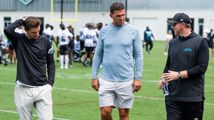 Jacksonville Jaguars general manager James Gladstone, left, Jacksonville Jaguars is executive vice president of football operations Tony Boselli, center and Jacksonville Jaguars head coach Liam Coen, right, all talk on the field after the Jacksonville Jaguars’ mandatory minicamp Tuesday June 10, 2025 at the Miller Electric Center in Jacksonville, Fla. [Doug Engle/Florida Times-Union]