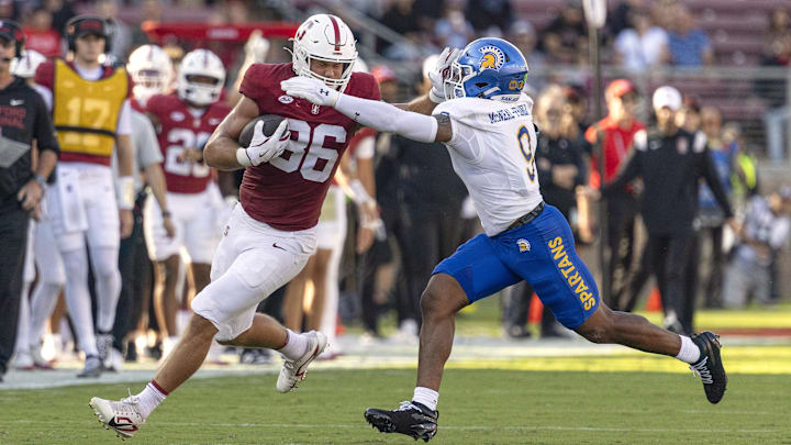 Sep 27, 2025; Stanford, California, USA;  Stanford Cardinal tight end Sam Roush (86) stiff arms San Jose State Spartans linebacker Noah McNeal-Franklin (9) during the first quarter at Stanford Stadium. Mandatory Credit: Stan Szeto-Imagn Image