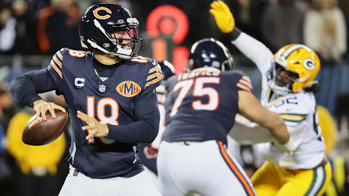 Dec 20, 2025; Chicago, Illinois, USA; Chicago Bears quarterback Caleb Williams (18) prepares to throw a pass and offensive tackle Ozzy Trapilo (75) blocks against Green Bay Packers defensive end Rashan Gary (52) during the first quarter at Soldier Field. Mandatory Credit: Mike Dinovo-Imagn Images