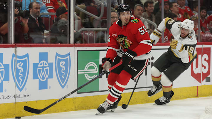 Mar 28, 2025; Chicago, Illinois, USA; Chicago Blackhawks defenseman Artyom Levshunov (55) and Vegas Golden Knights right wing Reilly Smith (19) battle for control of the puck during the second period at United Center. Mandatory Credit: Talia Sprague-Imagn Images