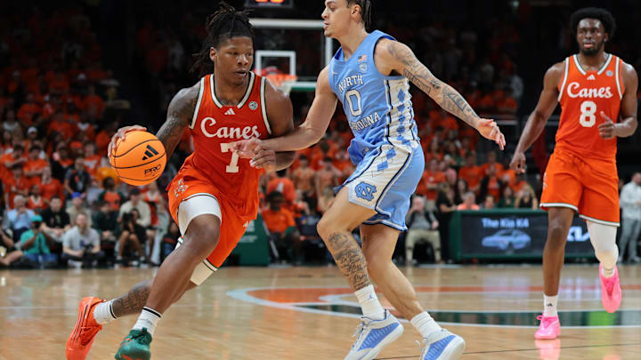 Feb 10, 2026; Coral Gables, Florida, USA; Miami Hurricanes forward Shelton Henderson (7) drives to the basket against North Carolina Tar Heels guard Kyan Evans (0) during the first half at Watsco Center. Mandatory Credit: Sam Navarro-Imagn Images