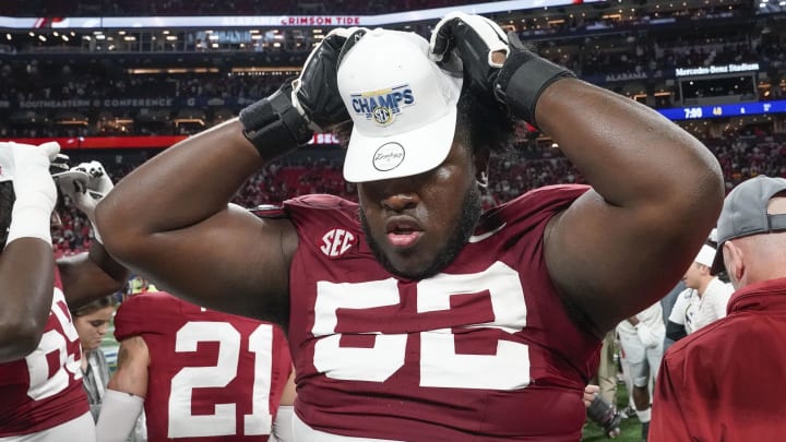 Dec 2, 2023; Atlanta, GA, USA;  Alabama Crimson Tide offensive lineman Tyler Booker (52) wears an SEC Championship hat at Mercedes-Benz Stadium. Alabama defeated Georgia 27-24 to claim the SEC Championship. Mandatory Credit: Gary Cosby Jr.-USA TODAY Sports