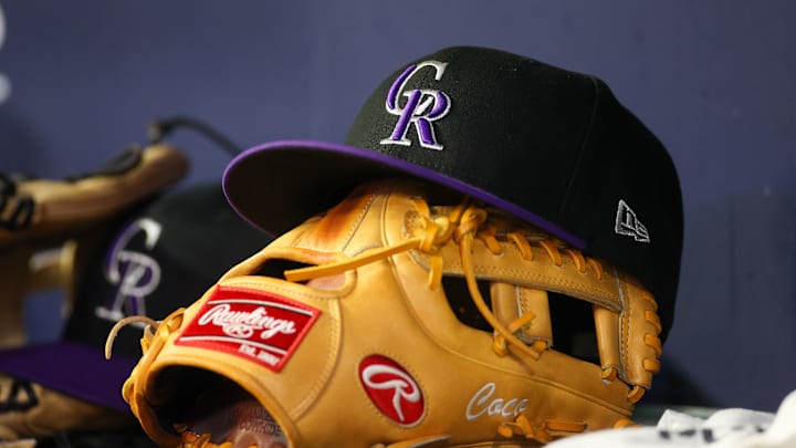 Jun 15, 2023; Atlanta, Georgia, USA; A detailed view of a Colorado Rockies hat and glove on the bench against the Atlanta Braves in the ninth inning at Truist Park. Mandatory Credit: Brett Davis-Imagn Images Jun 15, 2023; Atlanta, Georgia, USA; A detailed view of a Colorado Rockies hat and glove on the bench against the Atlanta Braves in the ninth inning at Truist Park. Mandatory Credit: Brett Davis-Imagn Images