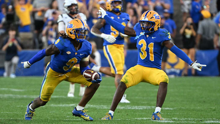 Sep 14, 2024; Pittsburgh, Pennsylvania, USA; Pittsburgh Panthers linebacker Kyle Louis celebrates with linebacker Rasheem Biles (31) after intercepting West Virginia Mountaineers quarterback Garrett Greene (6) in the fourth quarter at Acrisure Stadium. Mandatory Credit: Barry Reeger-Image Images Sep 14, 2024; Pittsburgh, Pennsylvania, USA; Pittsburgh Panthers linebacker Kyle Louis celebrates with linebacker Rasheem Biles (31) after intercepting West Virginia Mountaineers quarterback Garrett Greene (6) in the fourth quarter at Acrisure Stadium. Mandatory Credit: Barry Reeger-Image Images