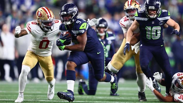 Jan 17, 2026; Seattle, WA, USA; Seattle Seahawks running back Kenneth Walker III (9) carries the ball as San Francisco 49ers cornerback Renardo Green (0) defends during the second half in an NFC Divisional Round game at Lumen Field.