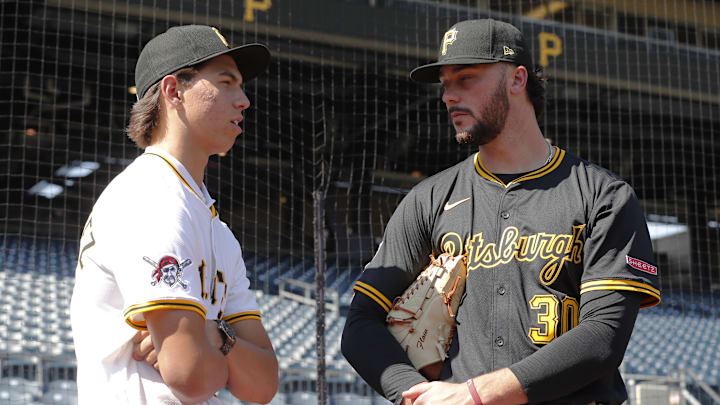 Jul 22, 2025; Pittsburgh, Pennsylvania, USA;  Seth Hernandez (left) the Pittsburgh Pirates first round and number six overall pick in the 2025 first year player draft talks with Pirates pitcher Paul Skenes (30) before the game against the Detroit Tigers at PNC Park. Mandatory Credit: Charles LeClaire-Imagn Images