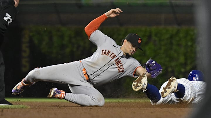 May 6, 2025; Chicago, Illinois, USA; Chicago Cubs second baseman Jon Berti (5) is caught stealing second base by San Francisco Giants shortstop Willy Adames (2) during the fifth inning at Wrigley Field. May 6, 2025; Chicago, Illinois, USA; Chicago Cubs second baseman Jon Berti (5) is caught stealing second base by San Francisco Giants shortstop Willy Adames (2) during the fifth inning at Wrigley Field.