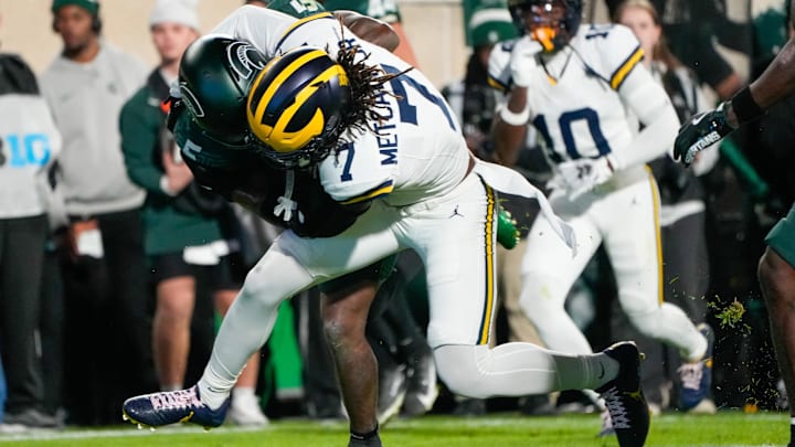 Oct 25, 2025; East Lansing, Michigan, USA; Michigan Wolverines defensive back TJ Metcalf (7) tackles Michigan State Spartans running back Makhi Frazier (5) during the first half at Spartan Stadium. Mandatory Credit: Brendan Mullin-Imagn Images Oct 25, 2025; East Lansing, Michigan, USA; Michigan Wolverines defensive back TJ Metcalf (7) tackles Michigan State Spartans running back Makhi Frazier (5) during the first half at Spartan Stadium. Mandatory Credit: Brendan Mullin-Imagn Images