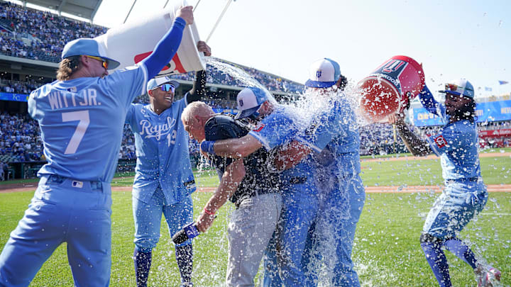 May 31, 2025; Kansas City, Missouri, USA; Sports broadcaster Joel Goldberg, Kansas City Royals designated hitter Vinnie Pasquantino (9) and left fielder Nick Loftin (12) are doused by shortstop Bobby Witt Jr. (7) and first baseman Salvador Perez (13) from the left side, and third baseman Jonathan India (6) from the right side after the win over the Detroit Tigers at Kauffman Stadium. Mandatory Credit: Denny Medley-Imagn Images