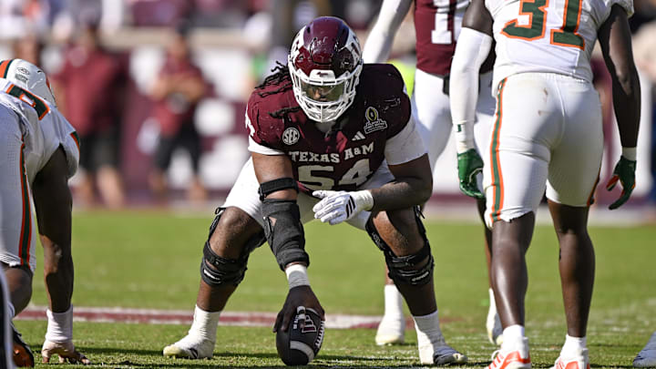 Dec 20, 2025; College Station, TX, USA; Texas A&M Aggies offensive lineman Mark Nabou Jr. (54) gets into position during the game between the Aggies and the Hurricanes at Kyle Field. Mandatory Credit: Jerome Miron-Imagn Images